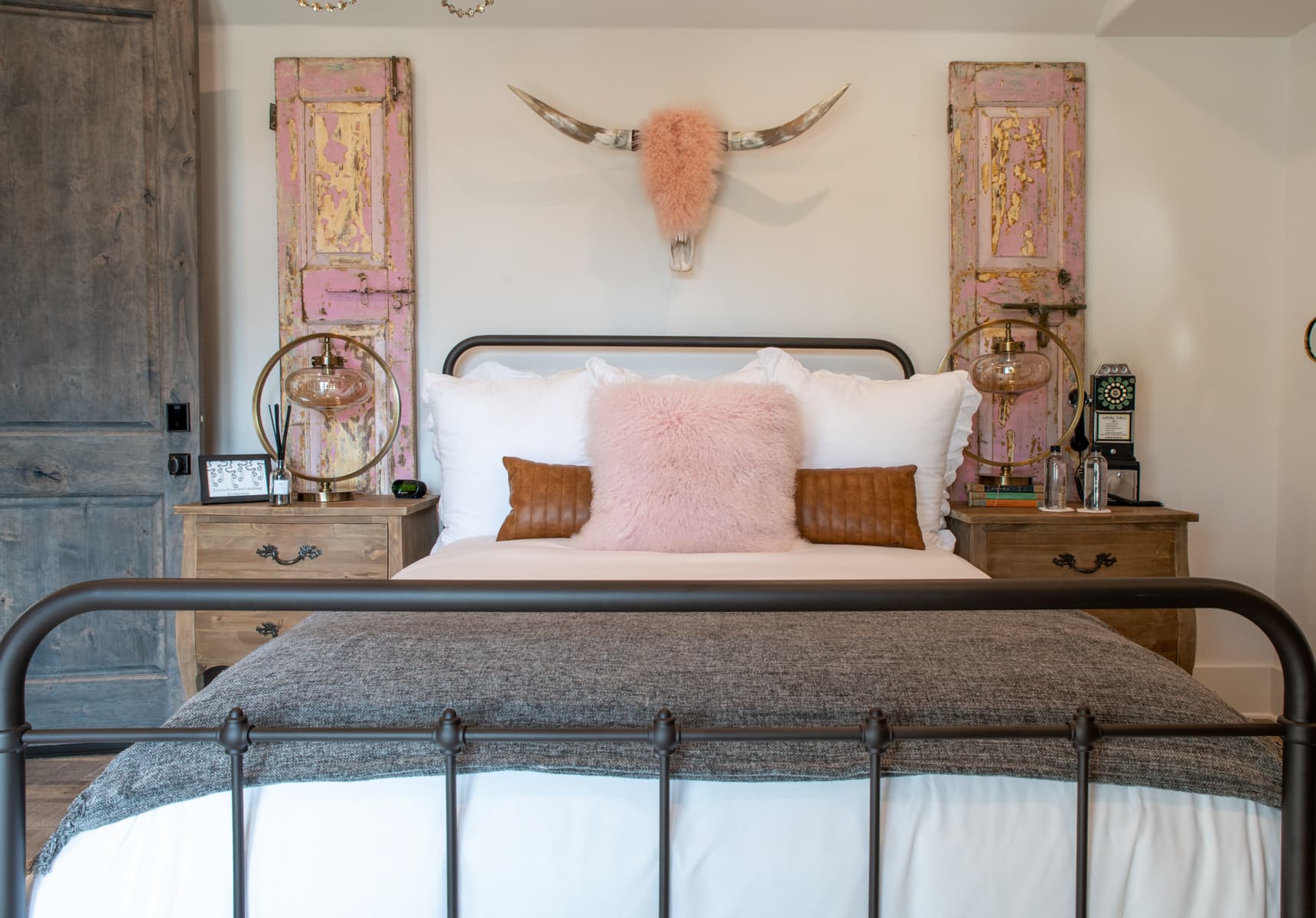 Bed in the Vivi with a cow skull over the headboard