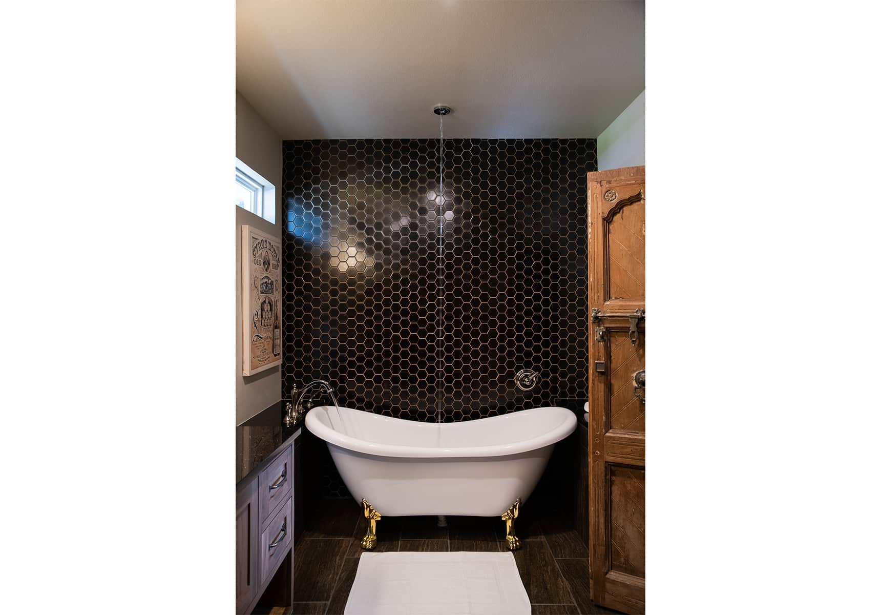 Clawfoot tub with a overhead waterspout on the ceiling