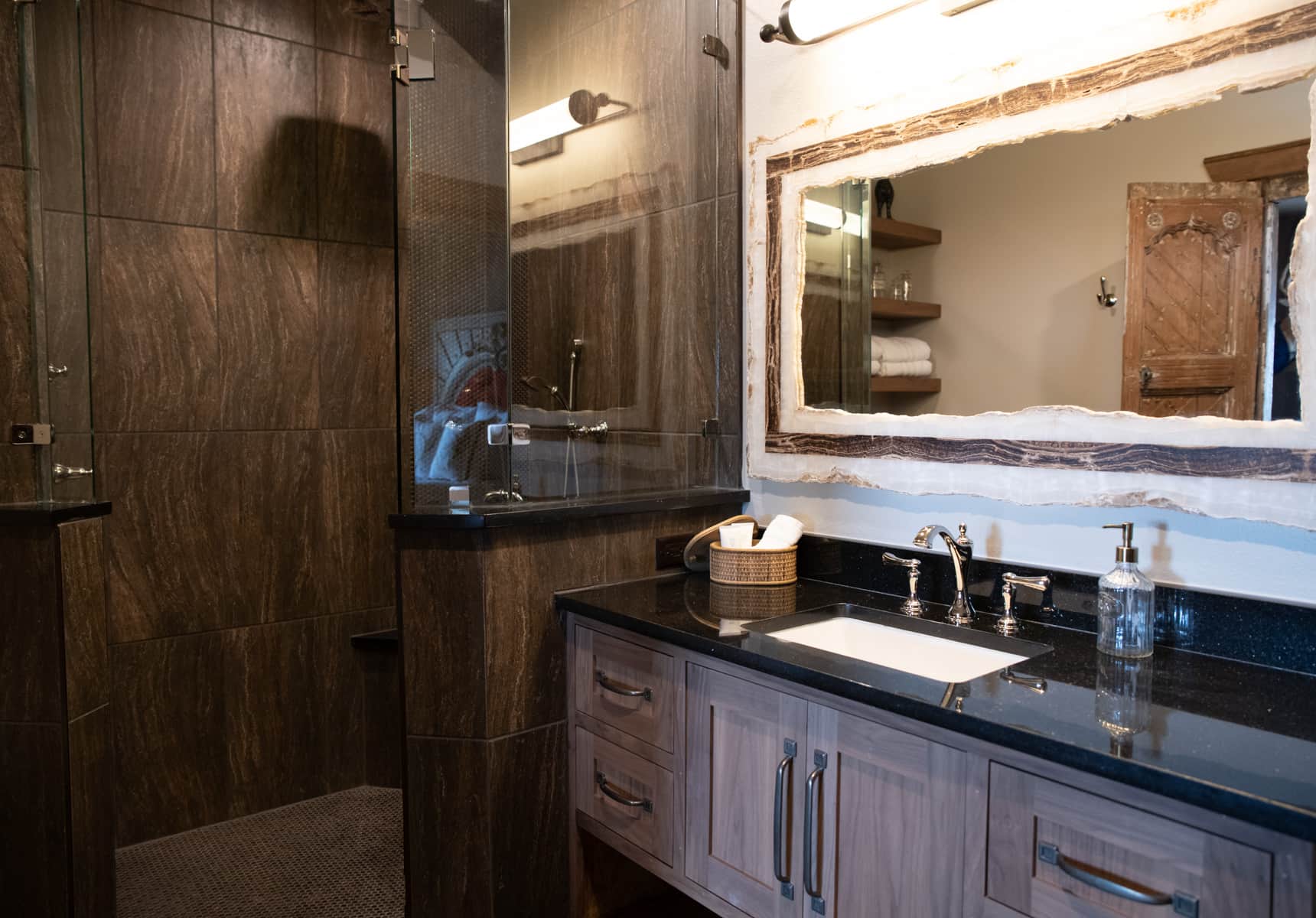 Bathroom with a walk-in shower, a counter and large mirror