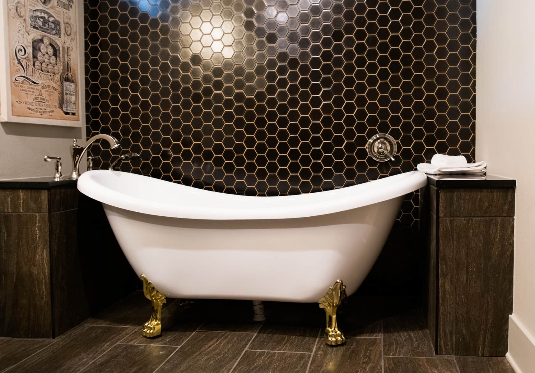 Clawfoot tub with a black hexagon tiles