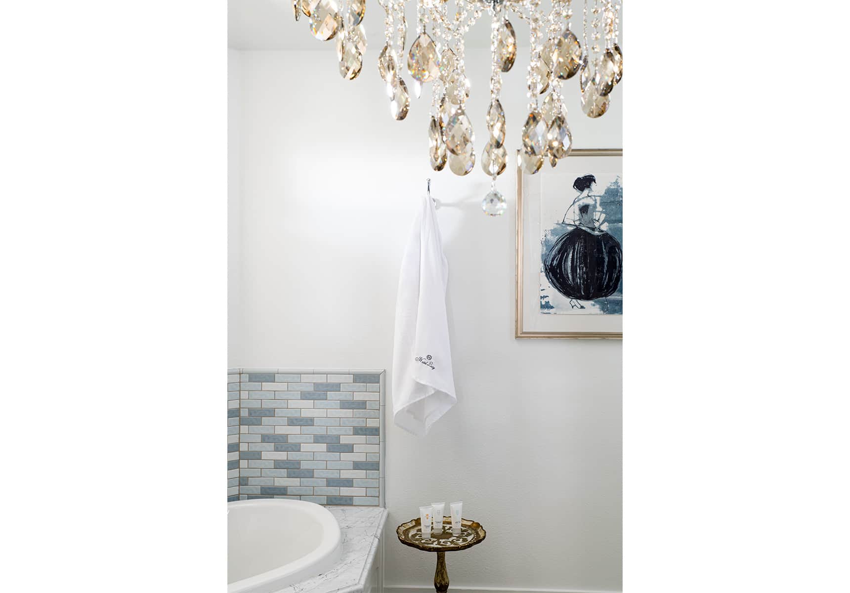 Chandelier in a bathroom with a tub
