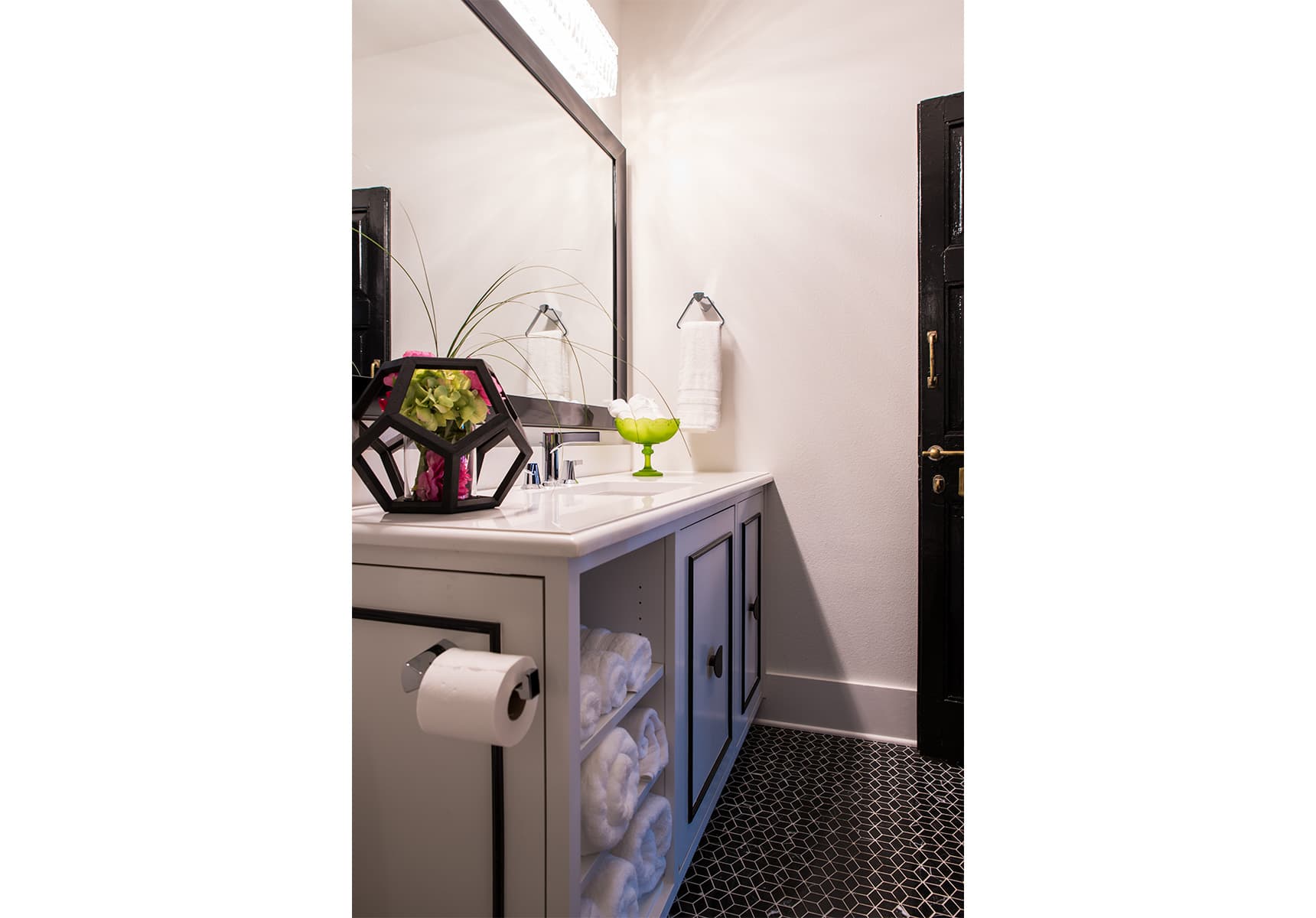 Bathroom counter and sink with large mirror and hexagonal flower vase