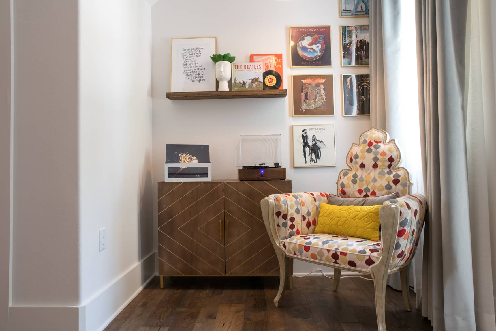 small seating area with a record player and a colorful chair